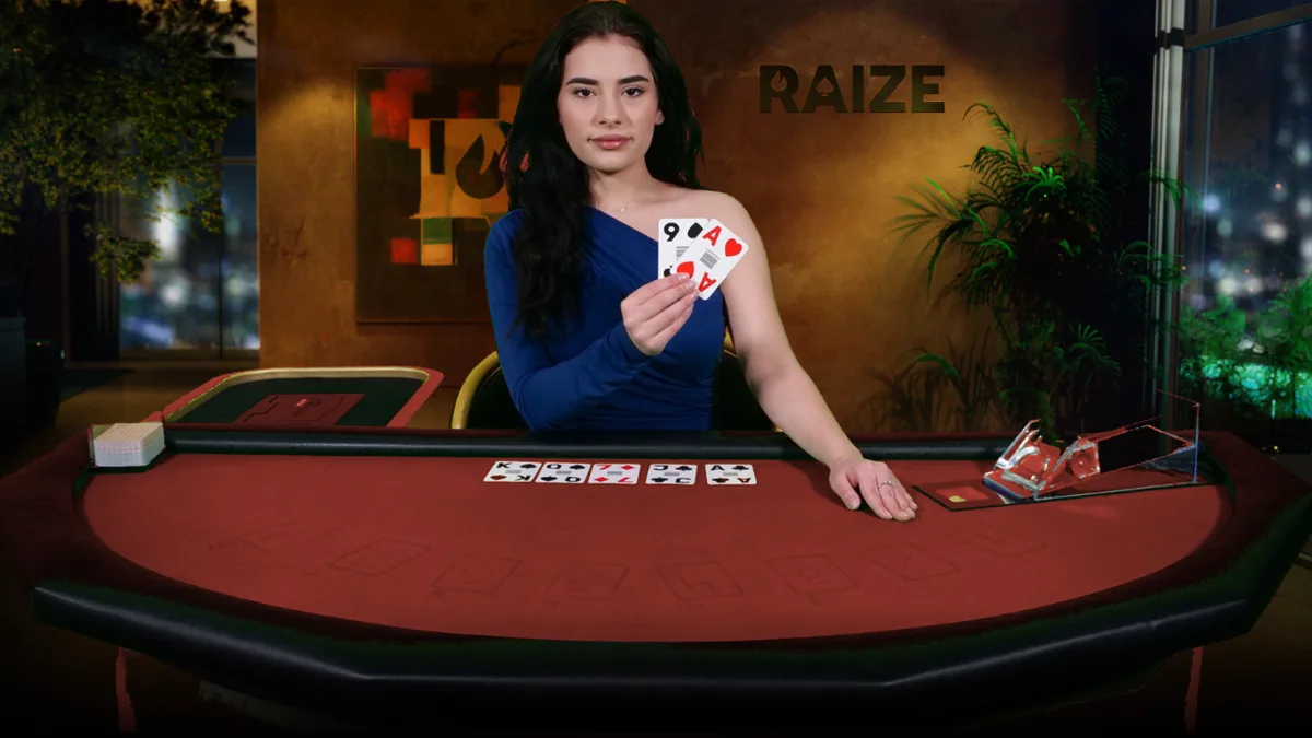 Dealer pictured behind a red poker table with cards